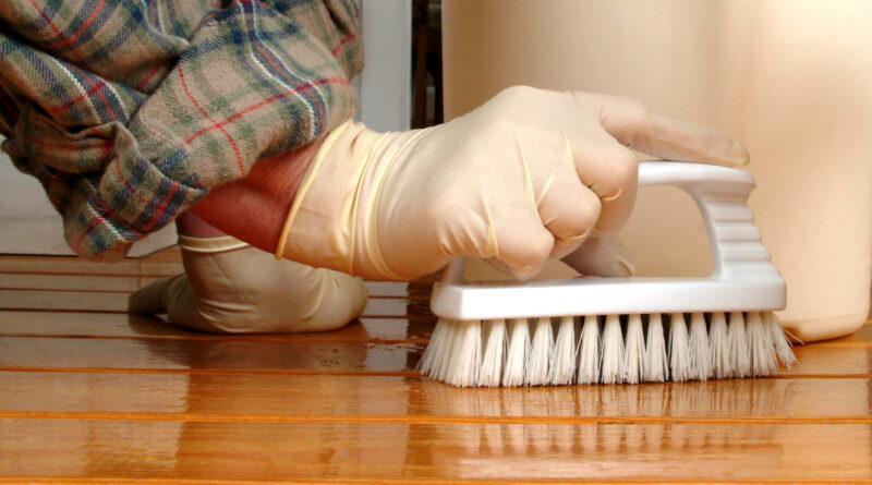 Scrubbing floor with brush