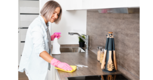 Lady cleaning kitchen countertop